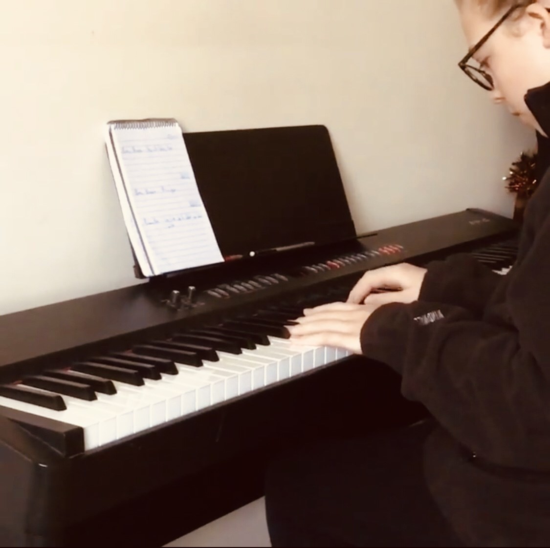 Talented young woman passionately playing the piano, symbolizing the diverse musical journey available at Alex Glew Music Education. Our comprehensive lessons cater to your preferences, whether it's piano, keyboard, or guitar, ensuring a customized and enriching learning experience.